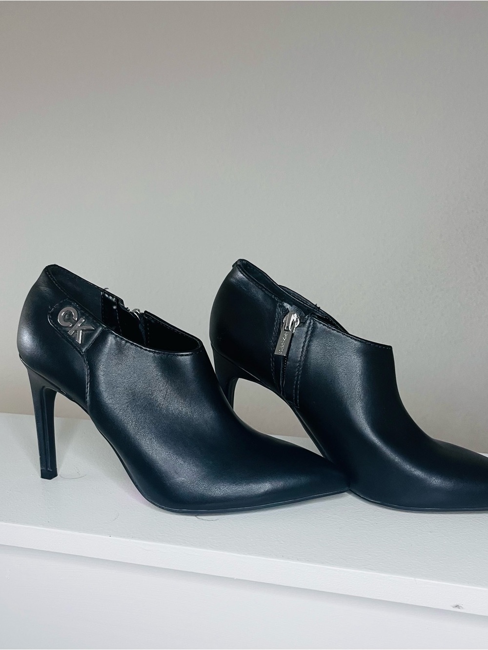 Calvin Klein Black Leather Pointed Ankle Booties with CK Accent